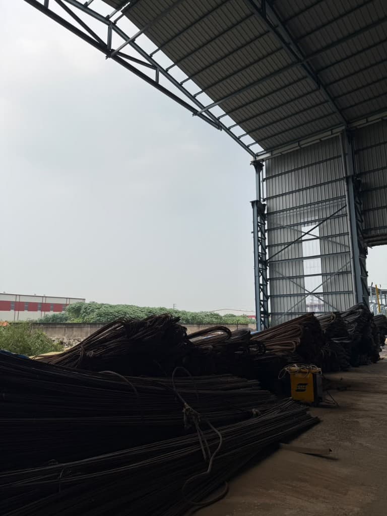 Covered warehouse bay with steel rebar and coil bundles